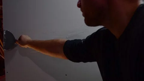 Working with wall plaster compund drywall prep material Stock Footage 259757409