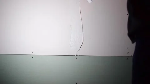 Working with wall plaster compund drywall prep material Stock Footage 259757438