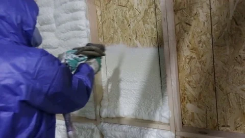 Working warms the wall with foam for the house Stock Footage 84119811