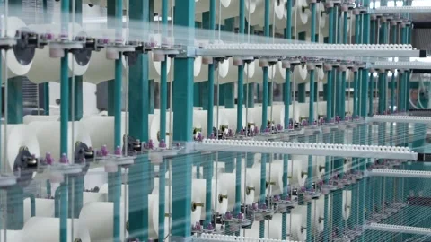 Working warping machine close-up, threads quickly unwinding from spools, loom Stock Footage 271729483