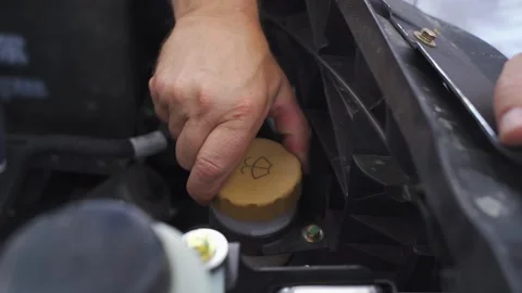 Working with a washer expansion tank plug for van maintenance tasks Stockbeeldmateriaal 293916785