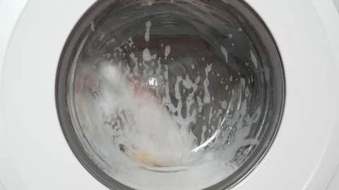 Working washing machine, front view with door and foam Stock Footage 194504835