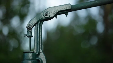 Working a water pump handle Stock Footage 90828210