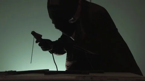 A working welder in an old closed welding mask performs welding work with electr Video stock 80941186