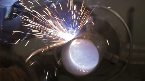 The working welder processes the metal, prepares the base. A man in a protective 스톡 동영상 87951260