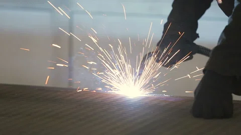 The working welder processes the metal, prepares the base. A man in a protective Stock Footage 87952312