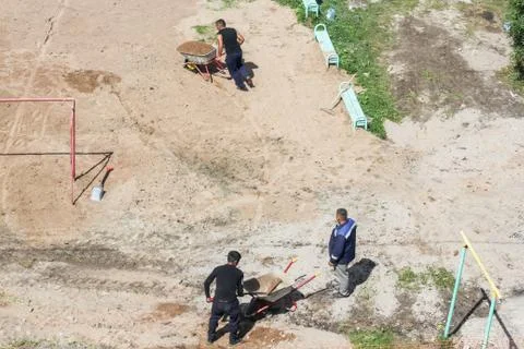 Working with wheelbarrows transporting sand. Photos