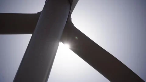 A working wind turbine against a backdrop of blue sky Stock Footage 313465490