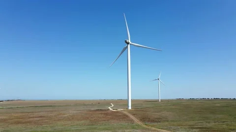 Working wind turbines standing on the field in summer Stock Footage