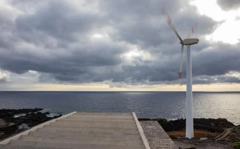 Working windmill on the ocean Stock Photos