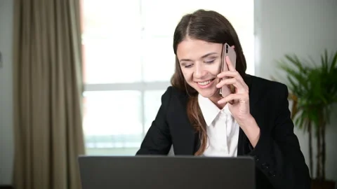 Working women are using computers and the phone to talk about work in office. Stock Footage 139162072