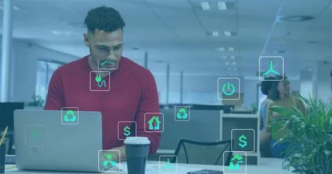 Working worker in red sweater typing on laptop at open office, with coffee and Stock Photos