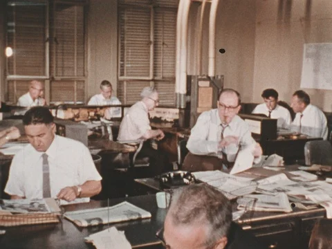Working writers at the office pass their articles to be proofread by editor. Video stock 74399395