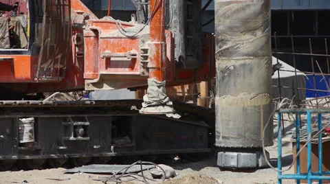 Workman command heavy drill machinery moving in construction site. Stock Footage 22630857