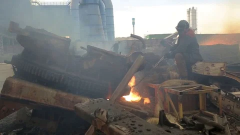 Workman cutting scrap metal with open fire Stock Footage 72713473