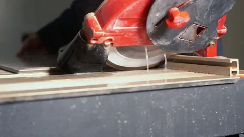 Workman cutting a tile or panel using circular saw Stock Footage 142105831