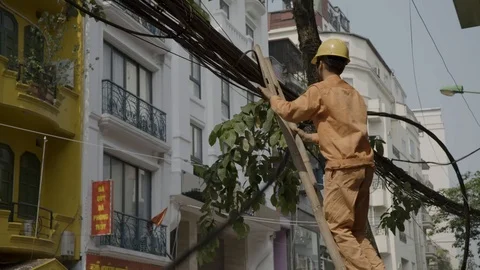 A workman fixes overhead cables Stock Footage 124833929