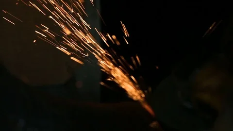Workman grinding the weld seam of pipe using a grinding wheel. HD Stock Footage 75240548