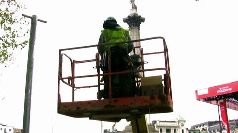Workman inside cherry picker in London, England. Stock Footage 23214125