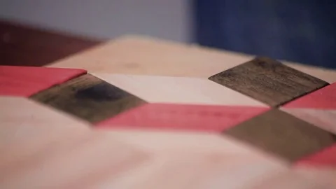 Workman makes a pattern of wooden parts Stock Footage 69205504