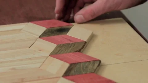 Workman makes a pattern of wooden parts Stock Footage 69205506