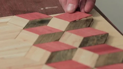 Workman makes a pattern of wooden parts Stock Footage 69205519