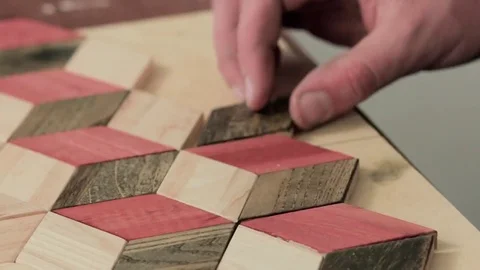 Workman makes a pattern of wooden parts Stock Footage 69205531