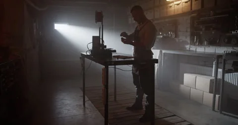 Workman measuring detail in dark workshop during work Stock Footage 259394907
