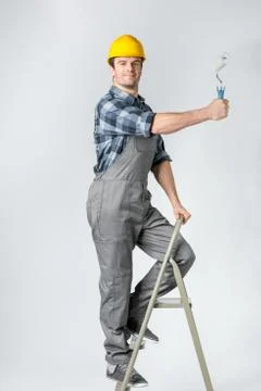 Workman with paint roller Stock Photos