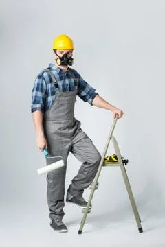 Workman with paint roller Stock Photos