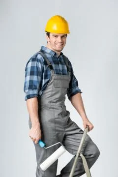 Workman with paint roller Stock Photos