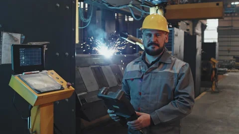 Workman Posing in Foreground of Welding Stock Footage 197591844