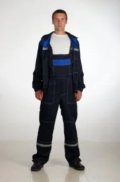 Workman  posing in overalls. Stock Photos