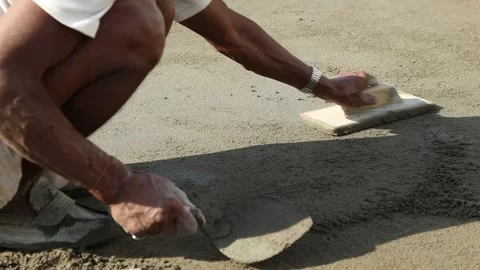 Workman pouring self-leveling screed on floor, spreading it and smoothing wit Stock Footage 154883981