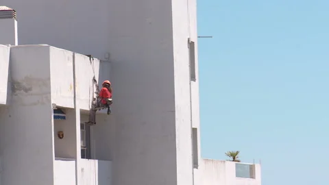 Workman preparing building for painting Stock Footage 160818271