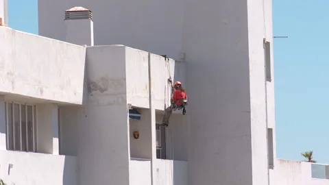 Workman preparing building for painting Stock Footage 160818285
