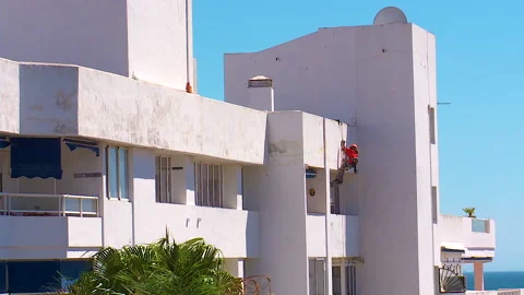 Workman preparing building for painting Stock Footage 160818301