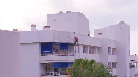 Workman preparing building for painting Stock Footage 160818341