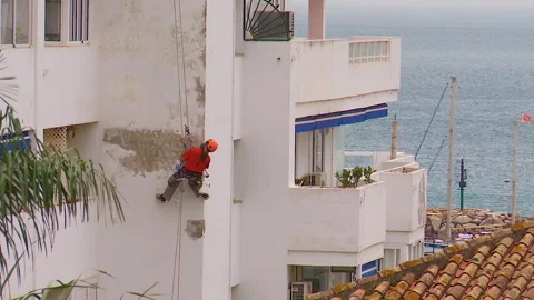 Workman preparing building for painting Stock Footage 160818343