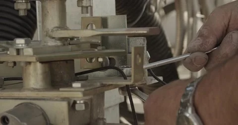 Workman protract two screws with  two hand wrenchs Stock Footage 150649245