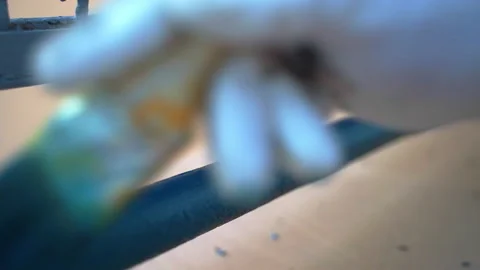 Workman renovating metal frame surface with blue paint coating, handyman Stock-Footage 226149189