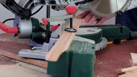 Workman sawing wood using a miter saw Stock Footage 69205294