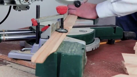 Workman sawing wood using a miter saw Video stock 69205295