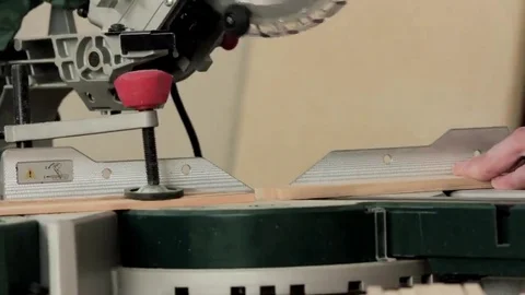 Workman sawing wood using a miter saw Stock Footage 69205339