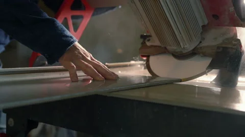 Workman slowly cutting a wall tile under water Stock-Footage 142105792