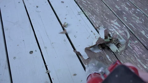 A workman stripping old paint with a heat gun Stock Footage 245098277