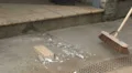 Workman sweeping up debris HD Footage