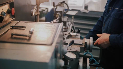 Workman in uniform working on lathe machine, close up. Concept of industry Stock Footage 104877596