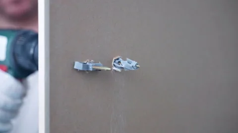 Workman using electric screwdriver for screws fixing on plasterboard, plastic Stock-Footage 302094635