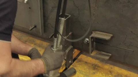 Workman Using an Industrial Riveter Stock Footage 77024160